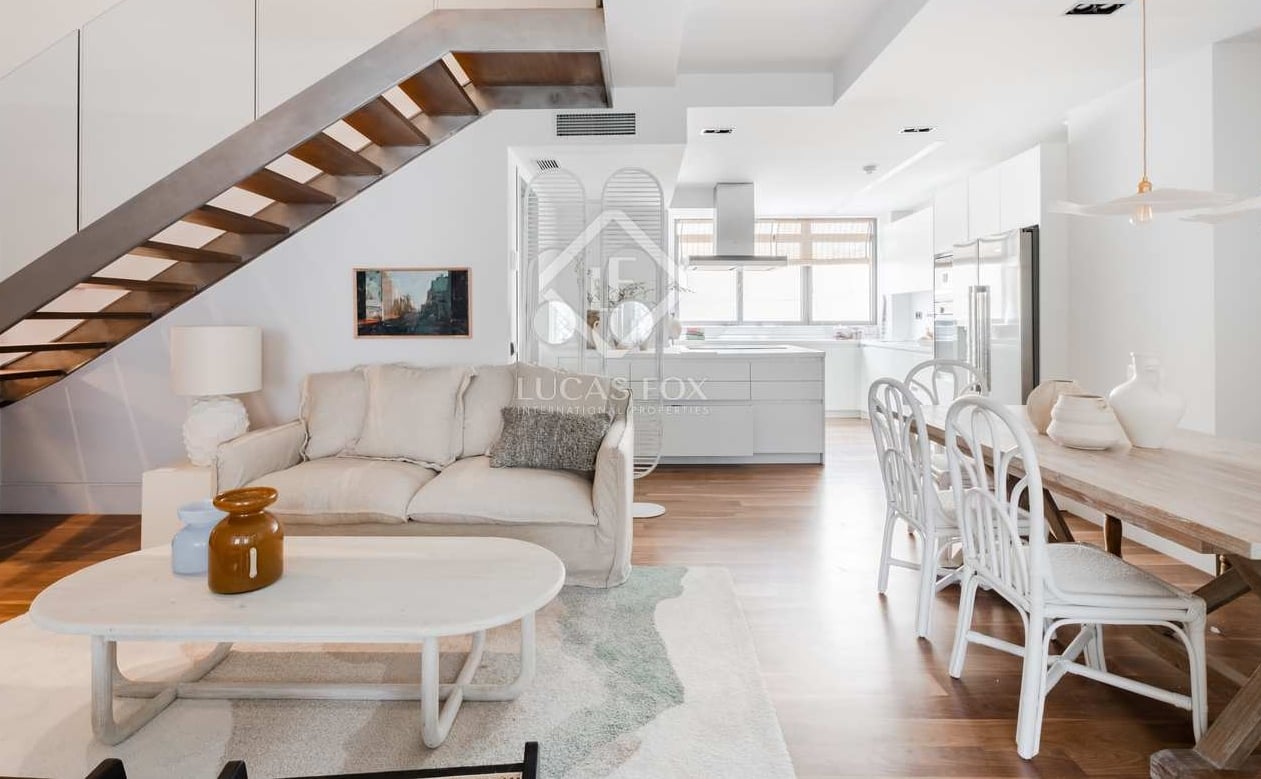 A white, light living room of a Madrid apartment. 