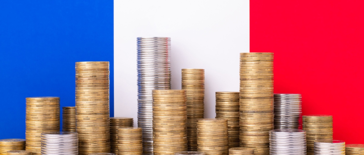 Piles of coins in front of the French flag