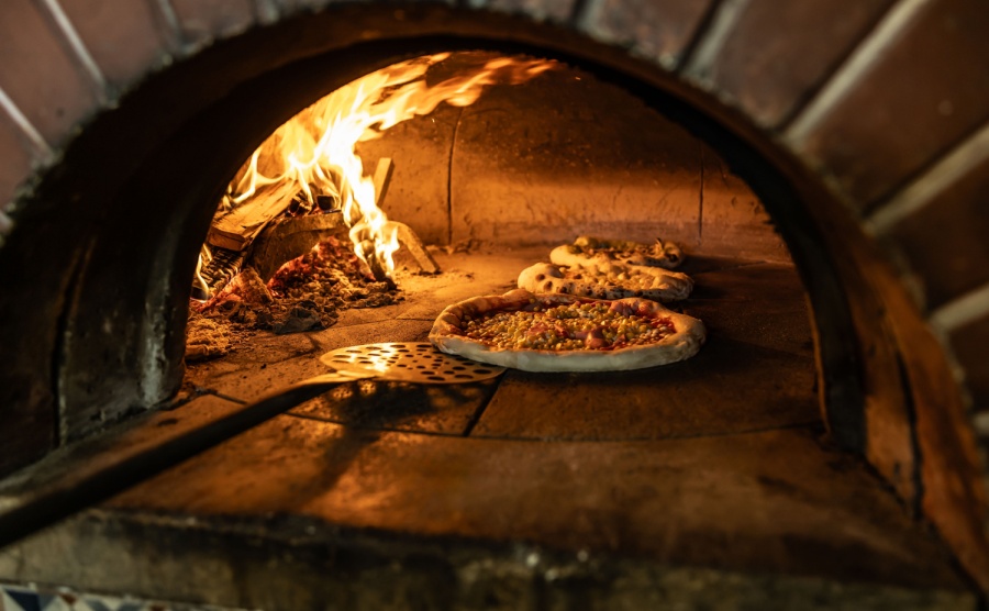 A neapolitan pizza in a traditional oven
