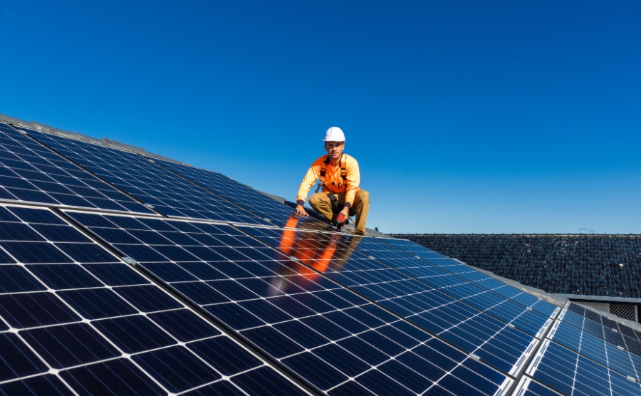 An engineer installs solar panels