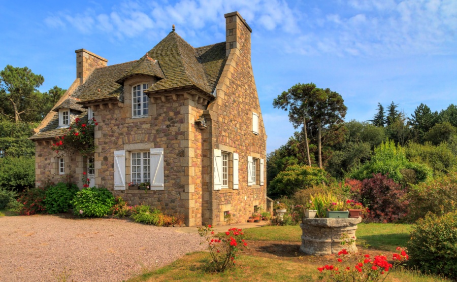 Beautiful view of a traditional French country house in Brittany, France, in summer with a blue sky