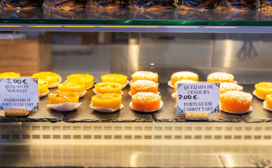 Display of a candy shop with queijada in Bolhao Market street food market in Porto or Oporto Portugal