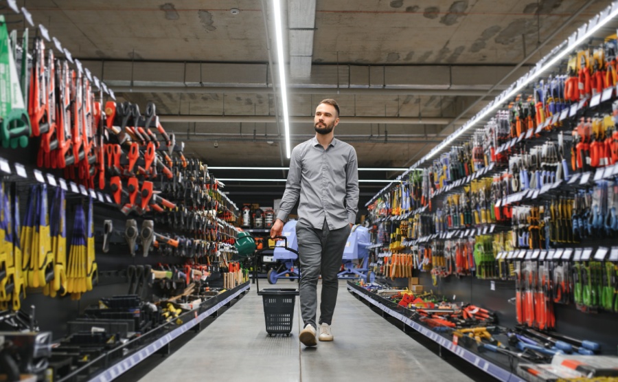 Portrait of happy mature man standing in hardware store