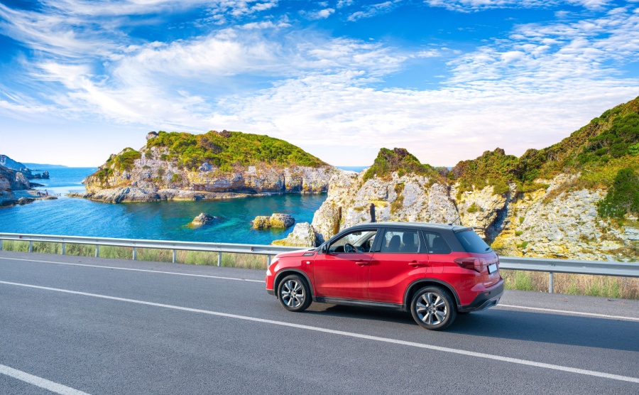 Red car drive on the road of mediterranean beach driving on coast of France Highway view on coast on way to summer holiday