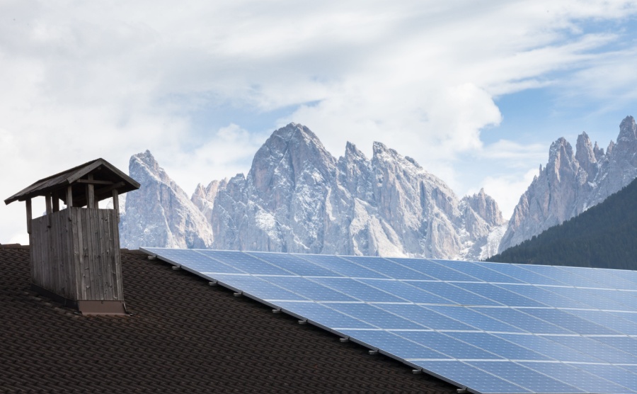 Rural scene of an alpine barn with photovoltaic panels