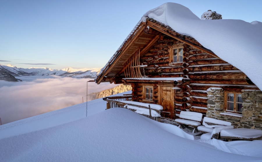 Snow covered mountain hut old farmhouse in the ski region of Saalbach Hinterglemm