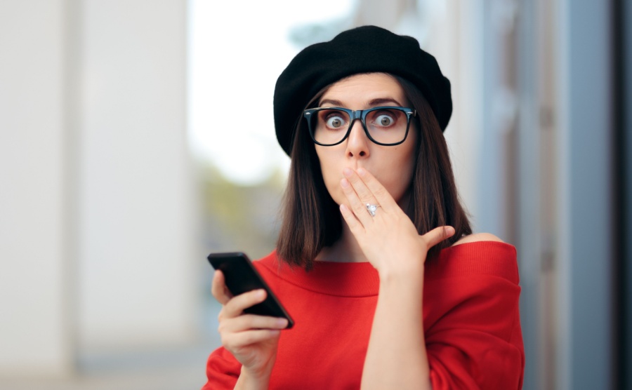 Surprised Fashion Woman Reading a Text Message