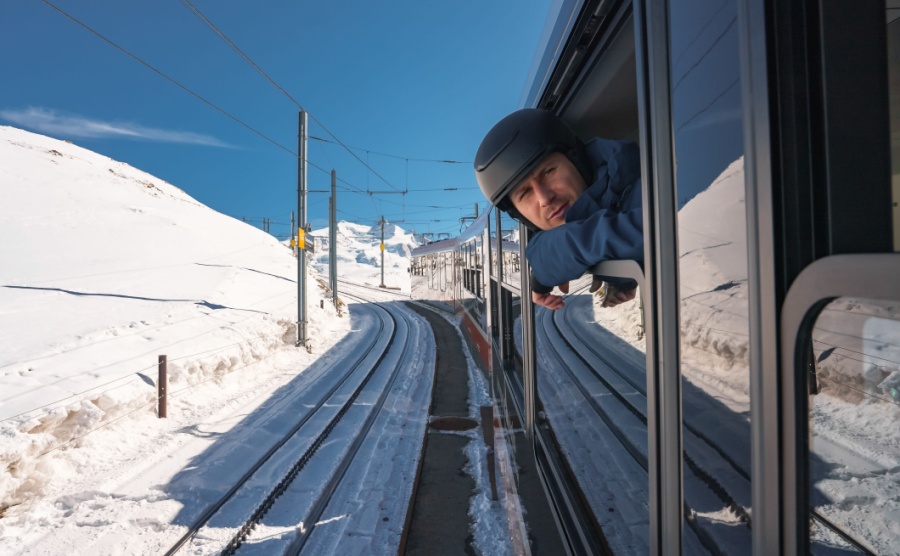 Young skier riding the glacier express train going through the Zermatt luxury ski resort