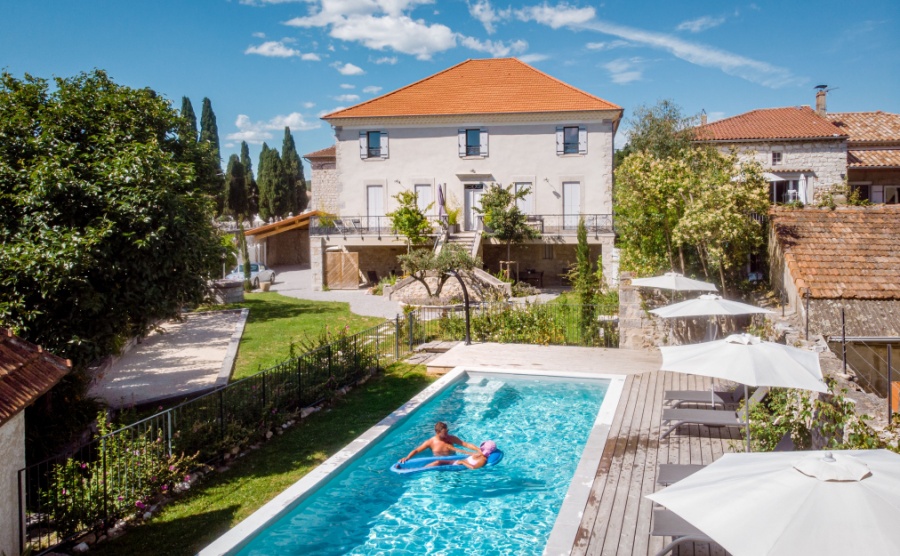 two person swim in the pool at the hotel. View from above, couple men and women in swimming pool of luxury vacation home in the Ardeche France Europe