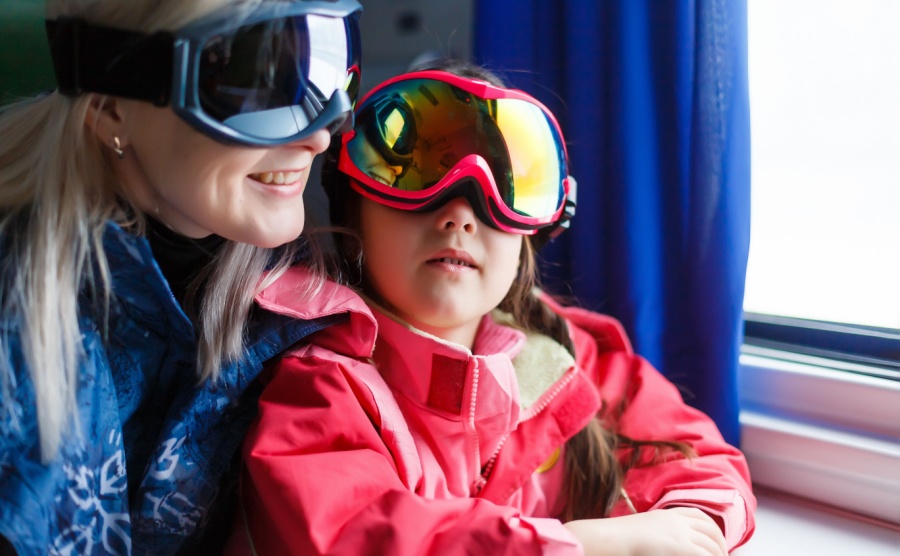 mother and daughter on a train to a ski resort