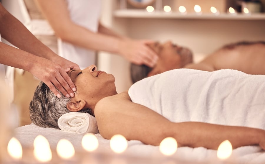 Couple getting massages in spa