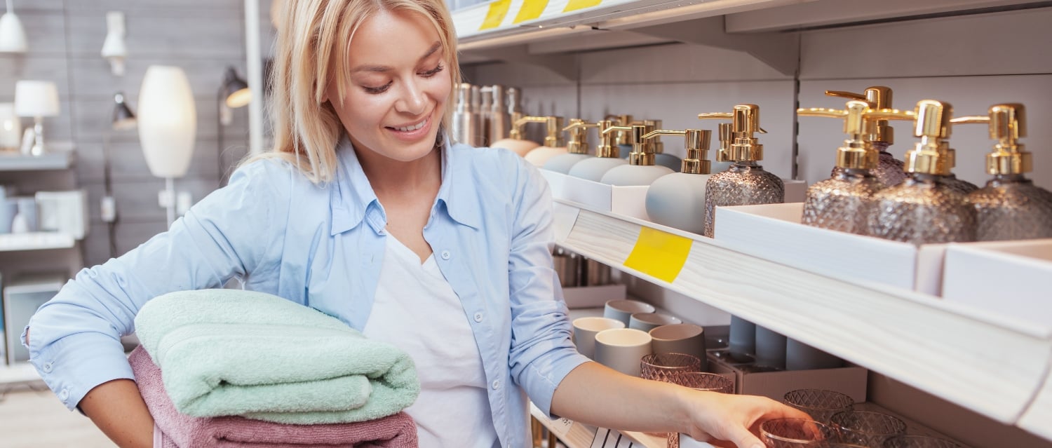 Woman buying towels and soap dispenser