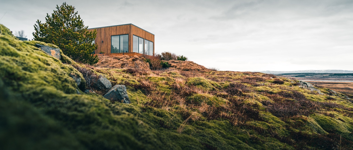 A tiny house on a grassy hill perfect for isolated vacation or just a peaceful relax in the connection with nature. Modern architecture in the Scandinavian countries