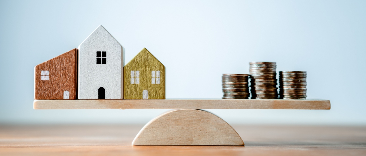 Balance scale Wooden plank of wood small home and coins money, comparison of income control expense saving money