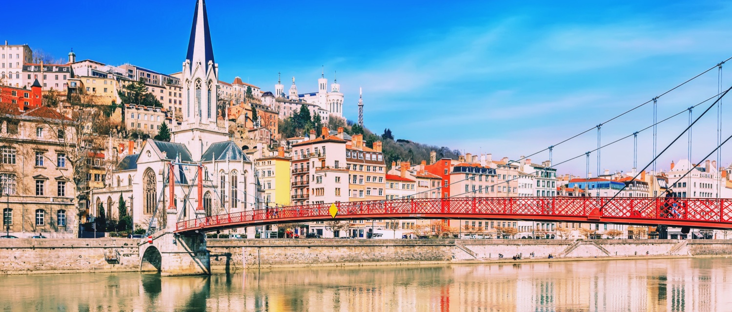 Pedestrian Saint Georges footbridge and the Saint Georges church in Lyon, France in a beautiful spring day