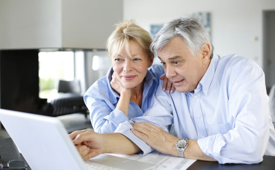 Senior couple looking at laptop