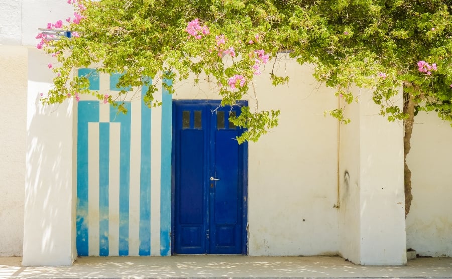 Blue door with Greek flag painted next to it