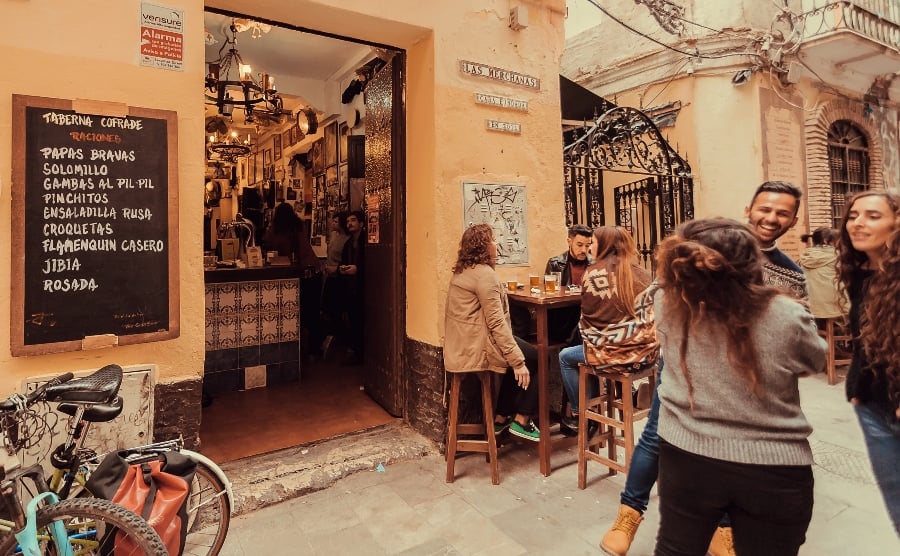 Friends meeting outside a cafe in Spain
