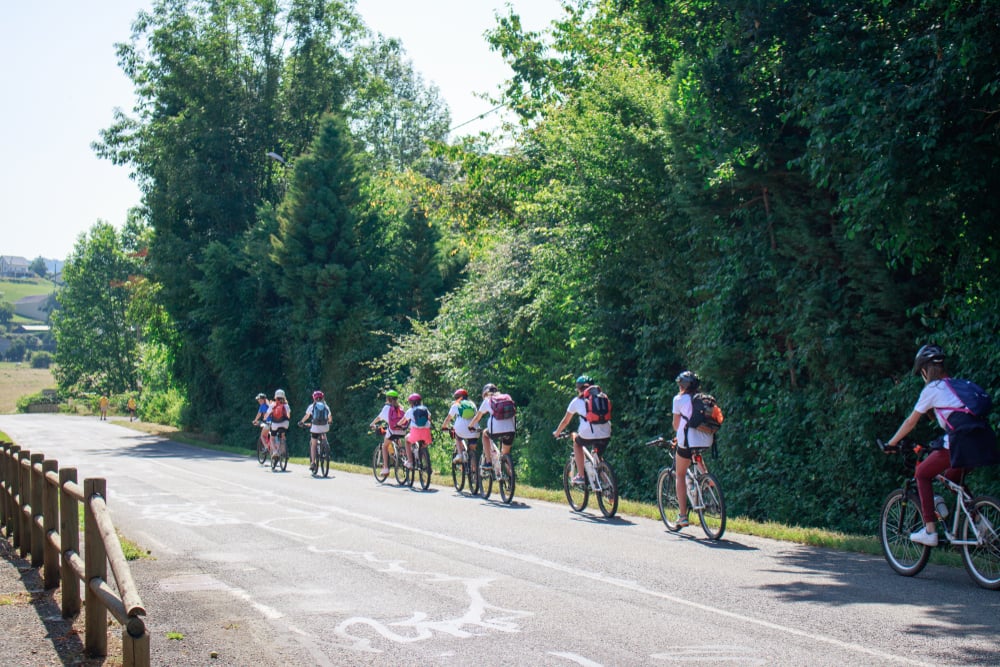 Teenagers group bike ride in the countryside - south France. Summer camp. Sports and outdoor activities conception