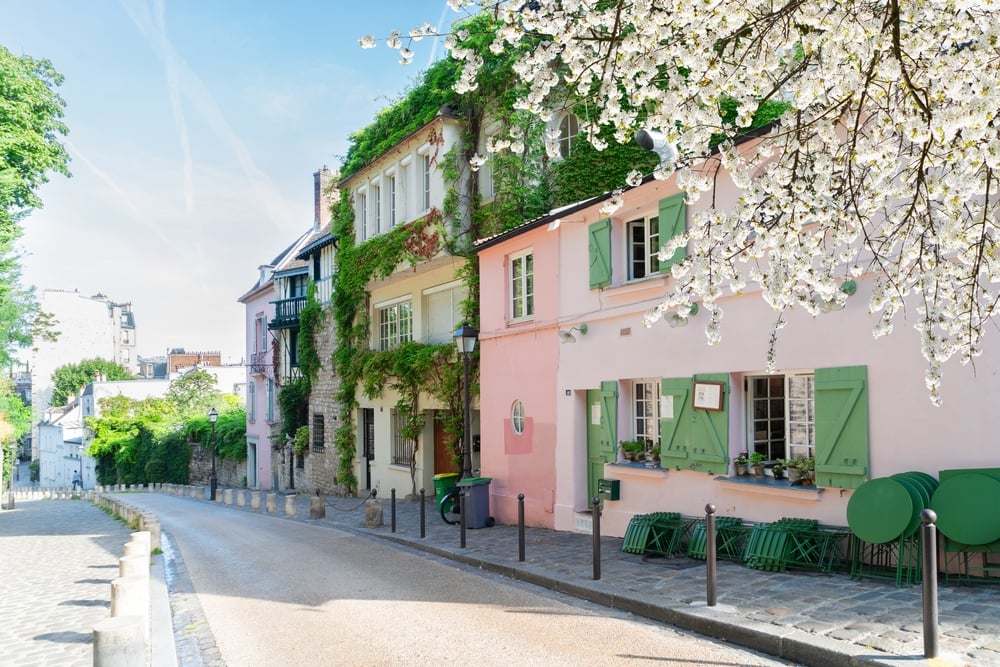 View of old street in quarter Montmartre in Paris, France. Cozy cityscape of Paris at spring. Architecture and landmarks of Paris.