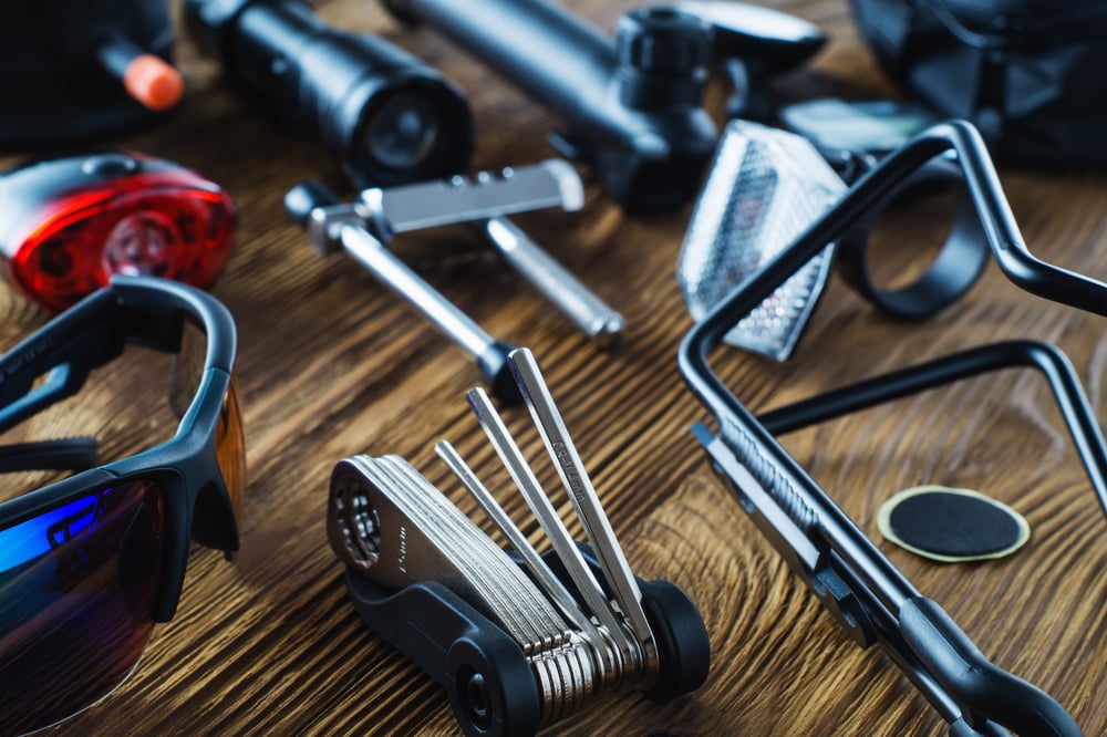 Tools and accessories set for cycling. Accessories for bicycles trips: universal screwdriver tool and screws, glasses, bicycle mirror, pump, water holder, speedometer. Bike tools and spares.