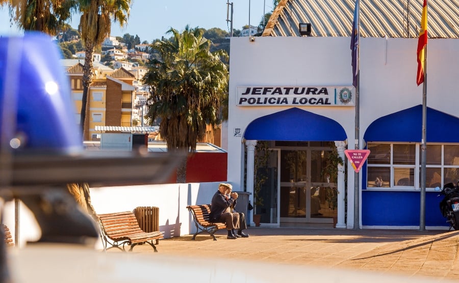 Two men outside a local police station in Spain