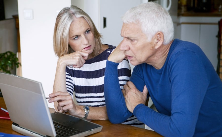 Concerned couple at a laptop