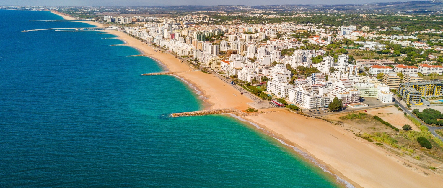 Wide sandy beach in touristic resorts of Quarteira and Vilamoura Algarve Portugal