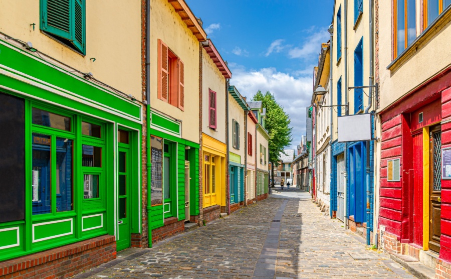 Amiens historical city centre Saint-Leu quarter, narrow cobblestone street with colorful houses buildings with multicolored bright walls. France landmarks, Hauts-de-France Region, Northern France