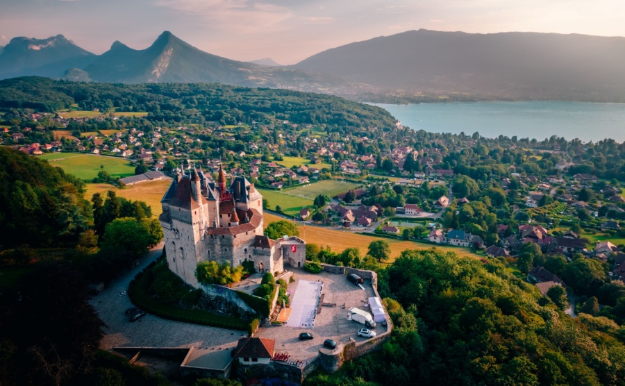 An aerial shot of the Castle of Menthon-Saint-Bernard overlooking the town and lake in Annecy, France