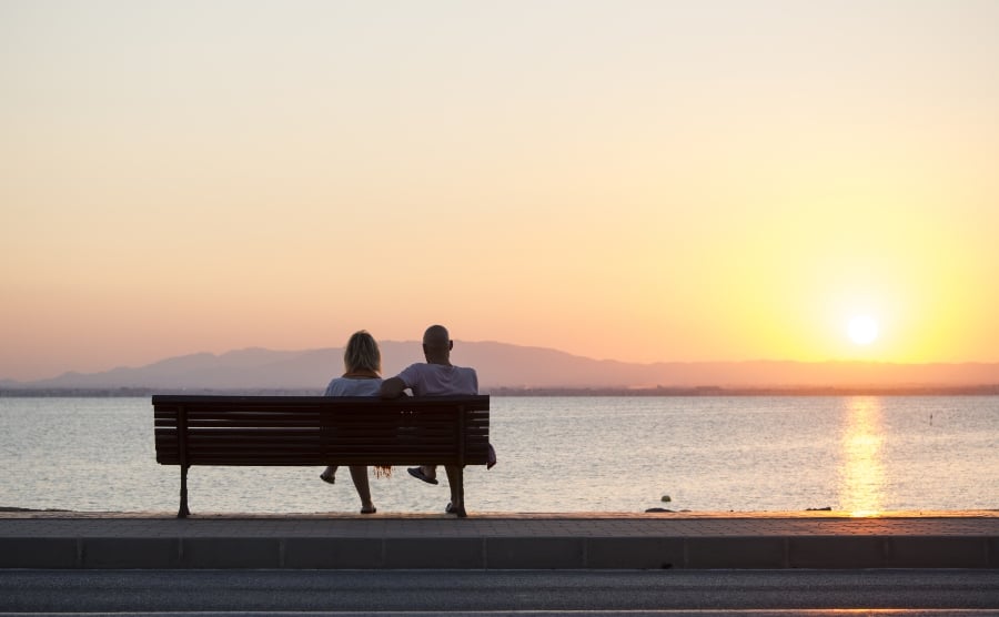 Couple watching the sunset in La Manga, Murcia