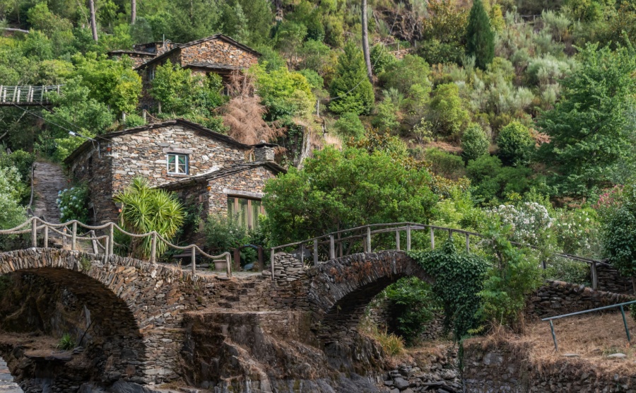 Two small bridges in shale stone and typical houses in the famous village of Foz d'Égua, Arganil PORTUGAL