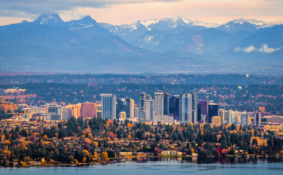 Bellevue Washington. The snowy Alpine Lakes Wilderness mountain peaks rise behind the urban skyline.