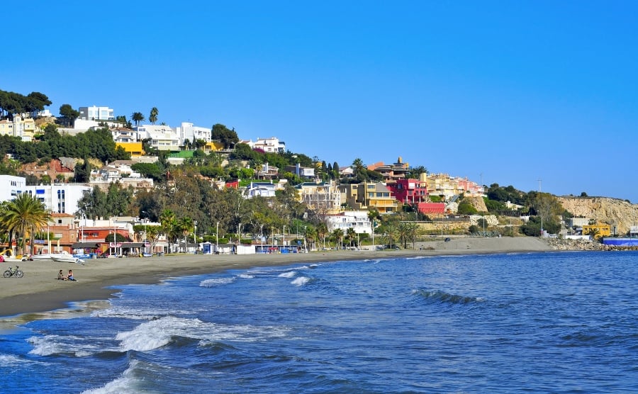 Beach lined with colourful buildings
