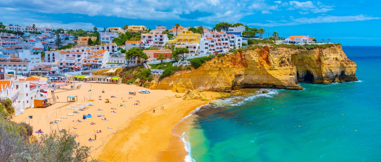 People are sunbathing on Praia de Carvoeiro beach in Portugal.
