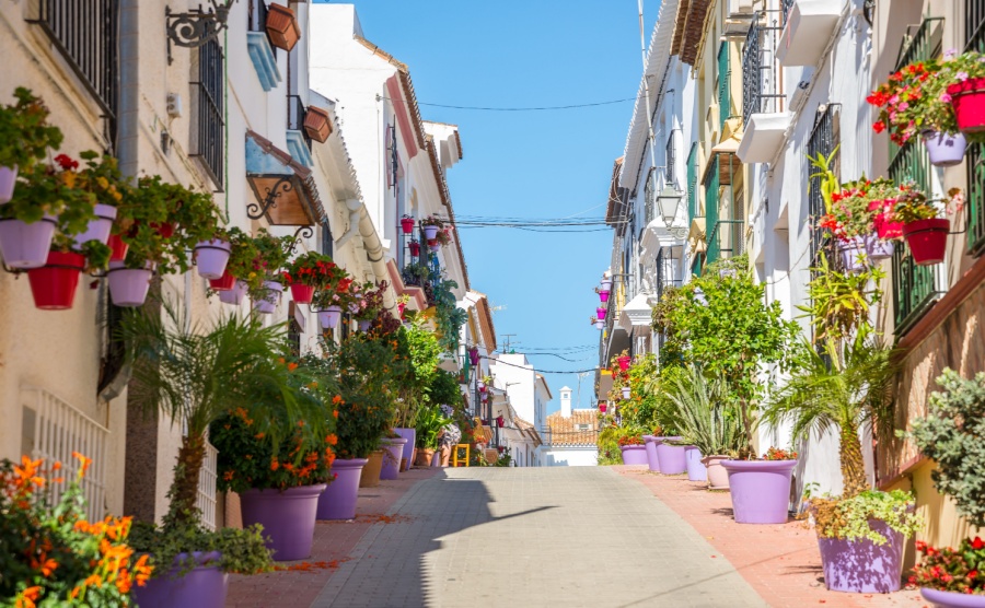 A typical street in old city Estepona with colorful flower pots. Estepona, Andalusia, Spain