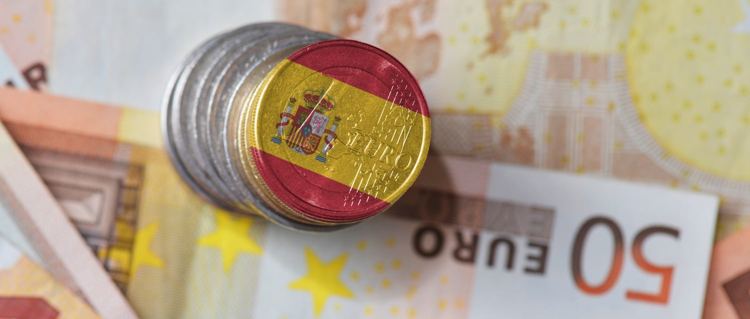Euro coins with Spanish flag on euro banknotes