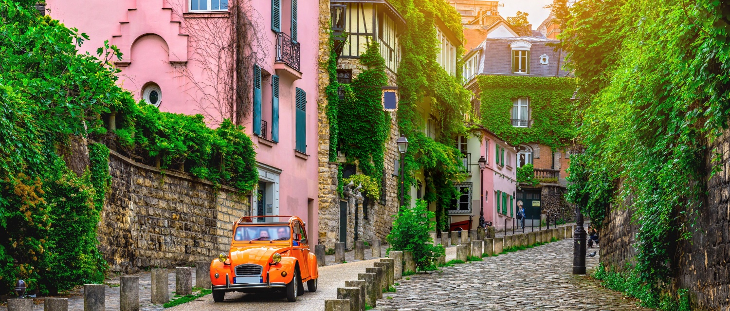 View of old street in quarter Montmartre in Paris, France. Cozy cityscape of Paris. Architecture and landmarks of Paris.