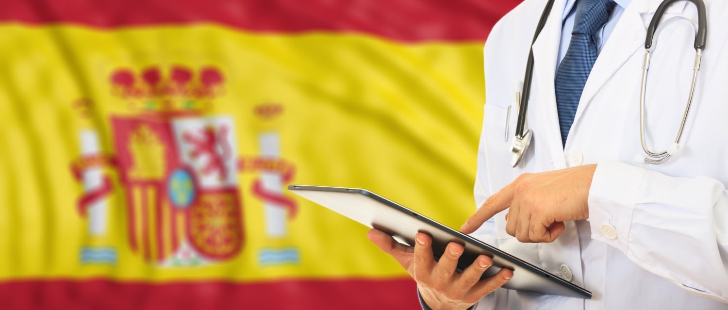 Doctor in front of Spanish flag