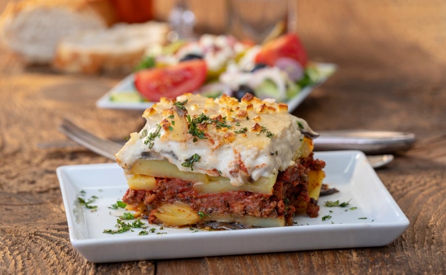 Greek moussaka on wooden table