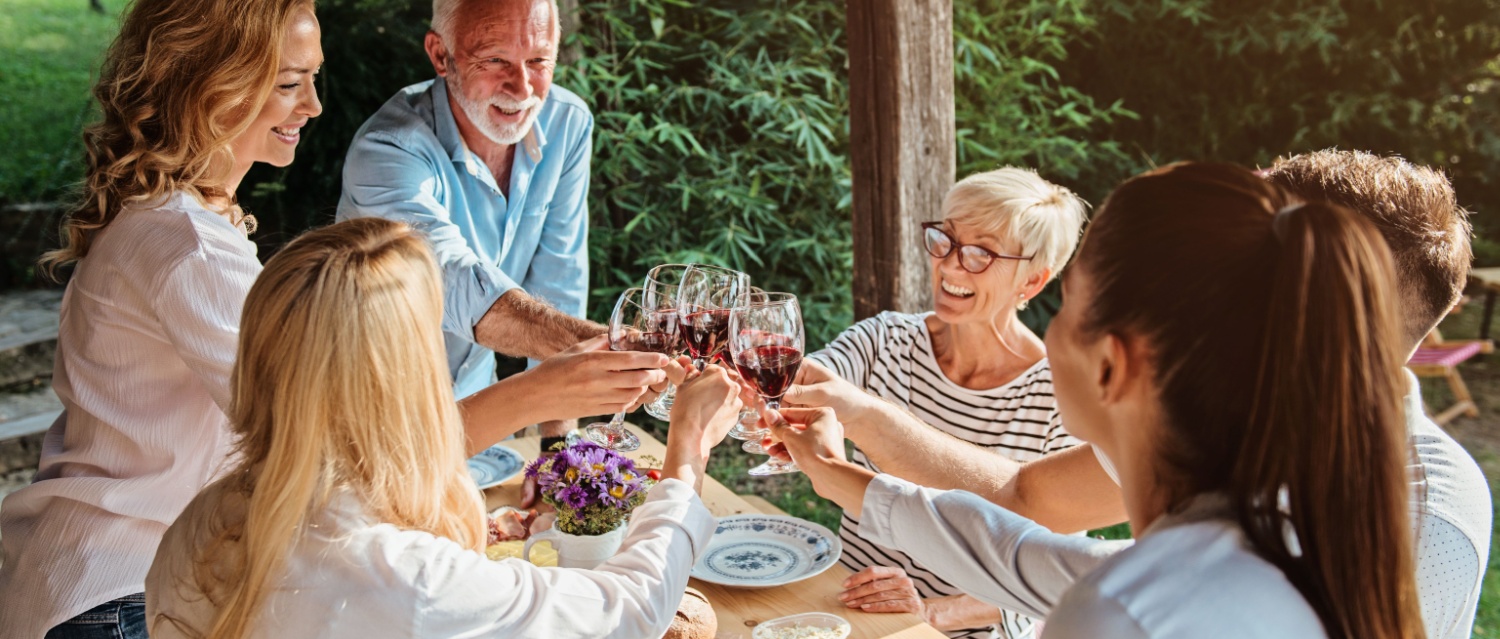 Family cheering over the dining table outdoors, celebration