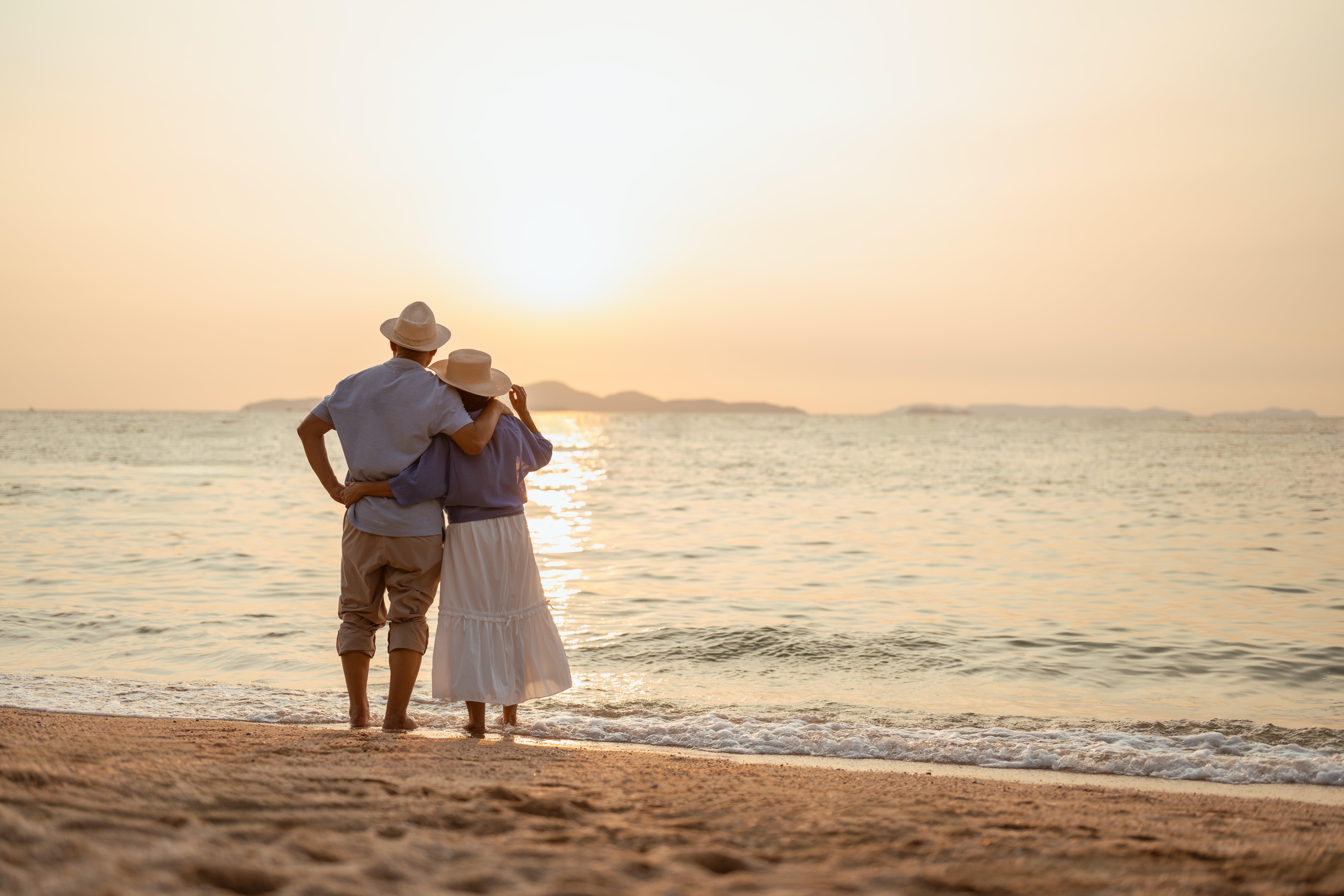 Senior couple on the beach at sunset
