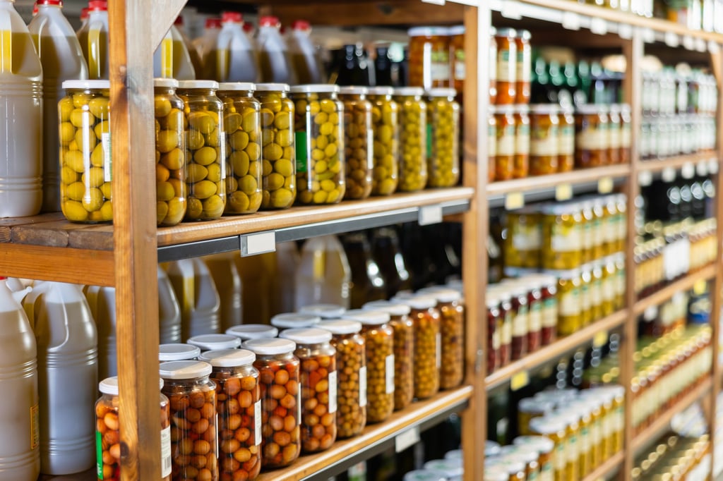 Jars of olives in supermarket