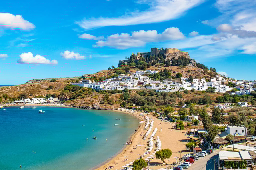 Rhodes beach with white houses and Acropolis