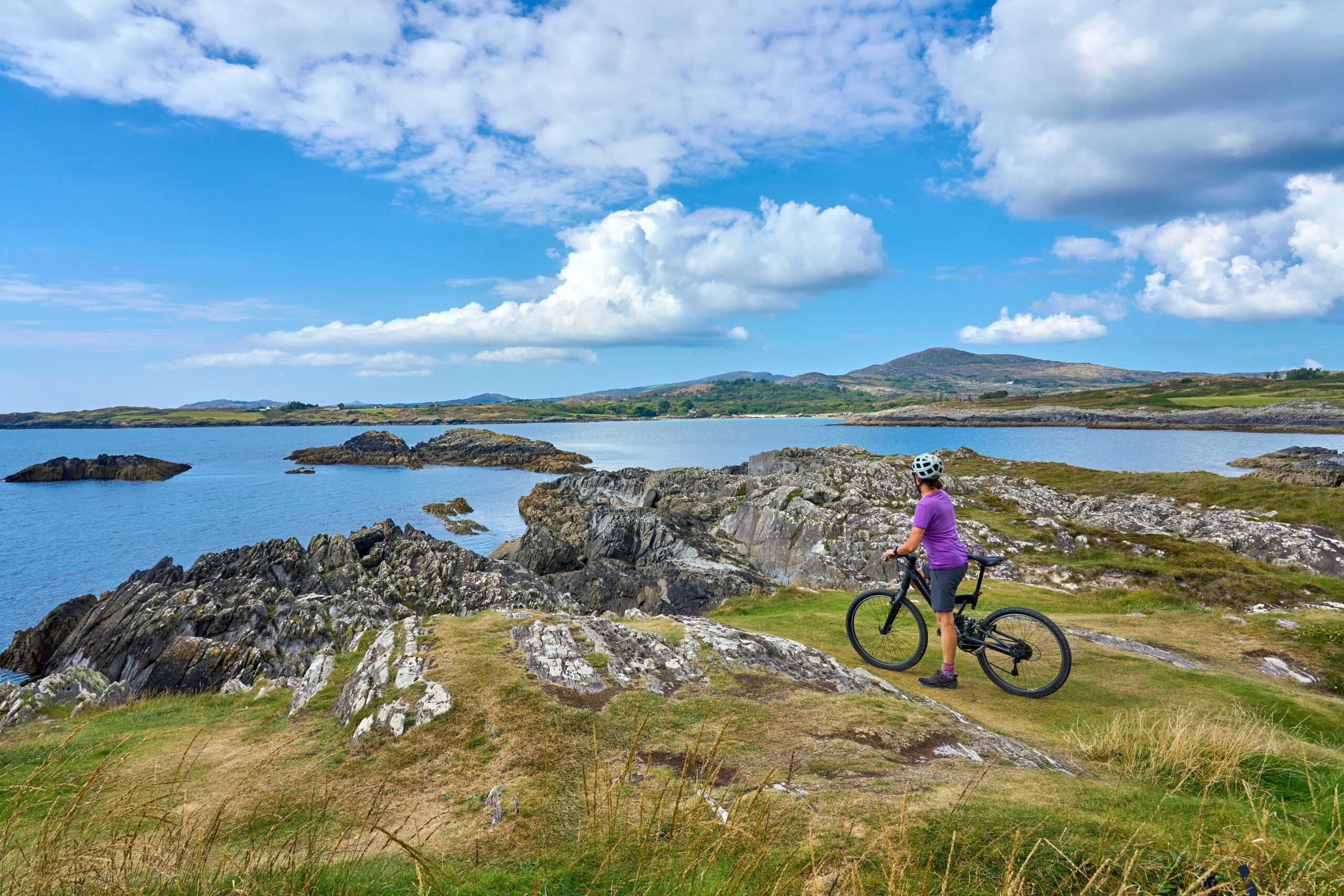 Female cyclist on a cliff