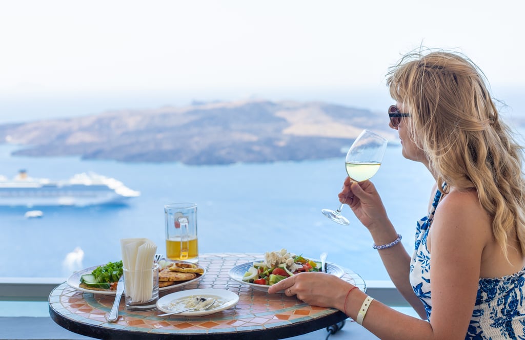 Woman eating at restaurant in Greece