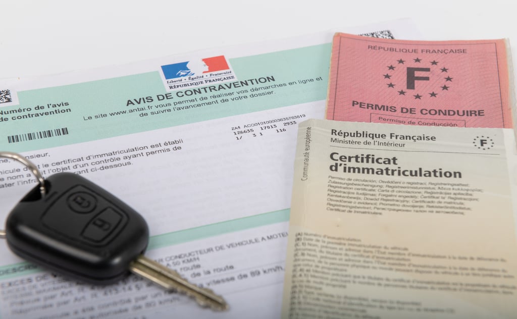 Customs declaration forms and a key on a desk for a move to France from the UK