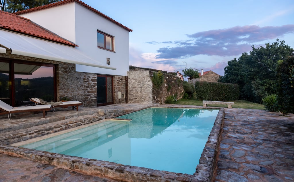 Renovated stone and white-rendered Portuguese villa with pool and garden, typical of the Silver Coast region