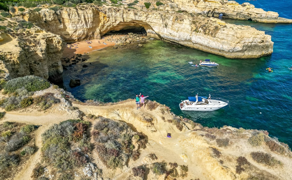 Sandy beach and whitewashed coastal village along the Algarve coastline in southern Portugal