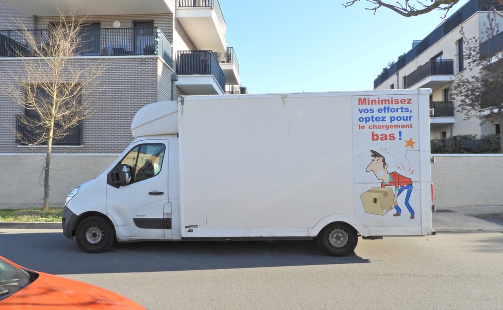 French removal van parked on a residential street, ready to deliver household belongings after an international move